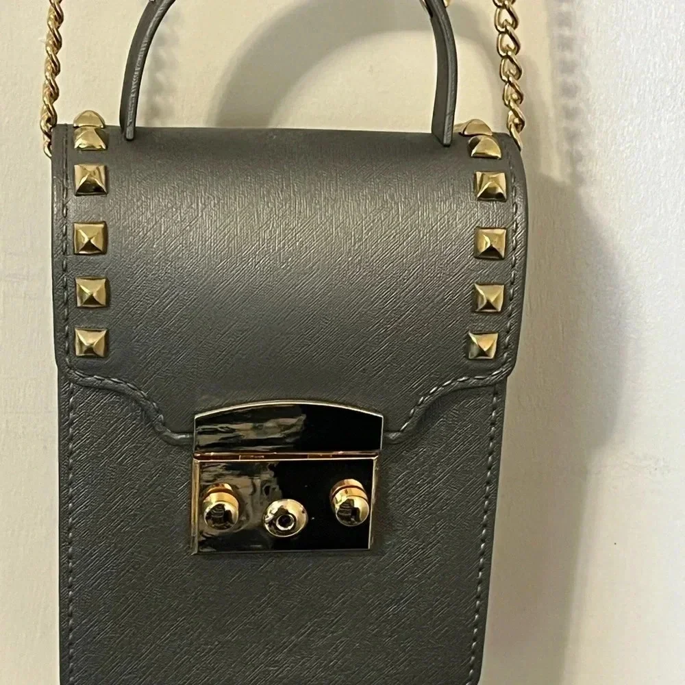Grey crossbody with gold studs gives a sassy stylish look for a night out